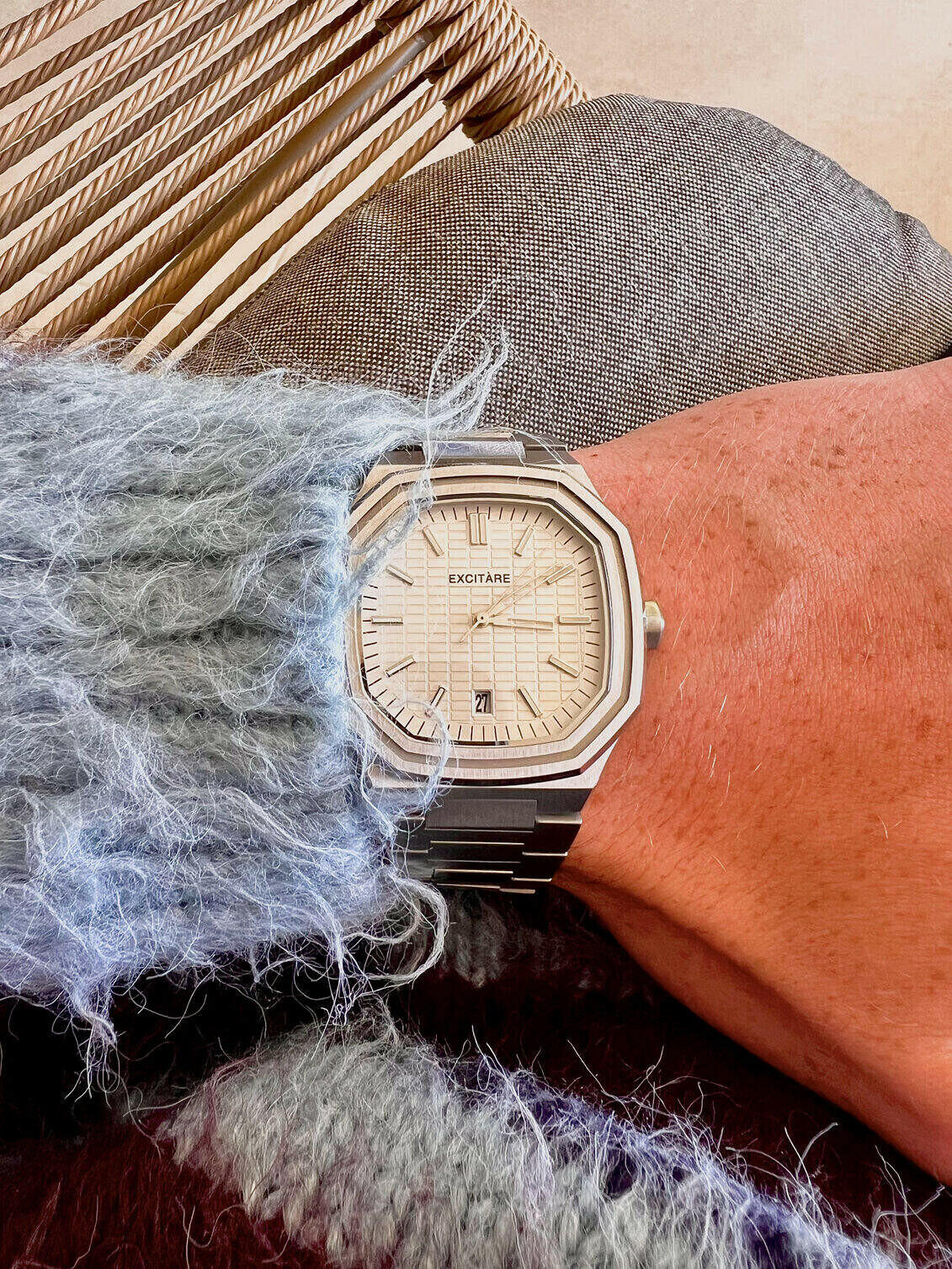 EXCITÀRE watch on a wrist with textured fabric background