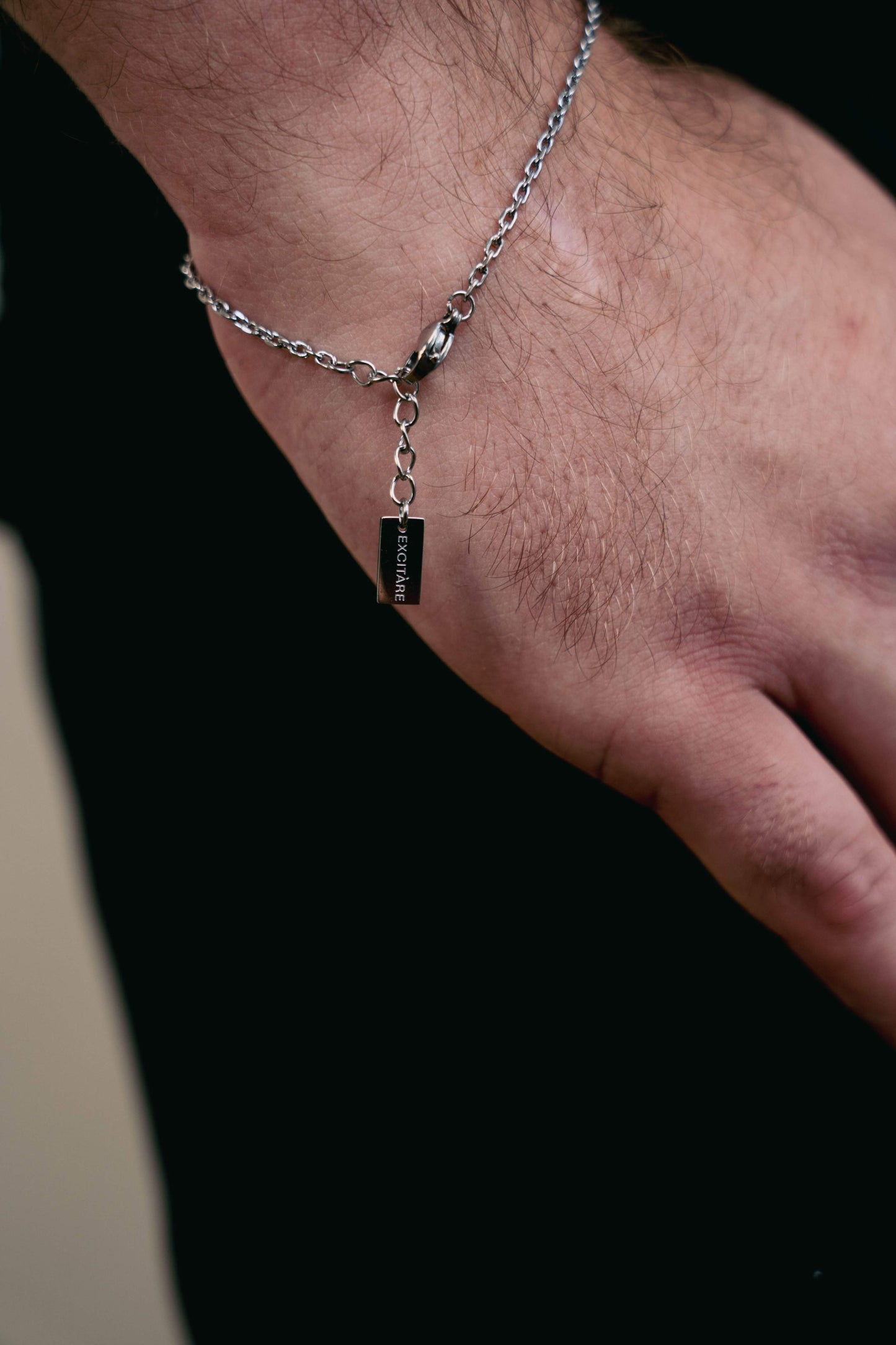 EXCITÀRE Nova Bracelet silver with close-up on clasp and engraved tag detail.