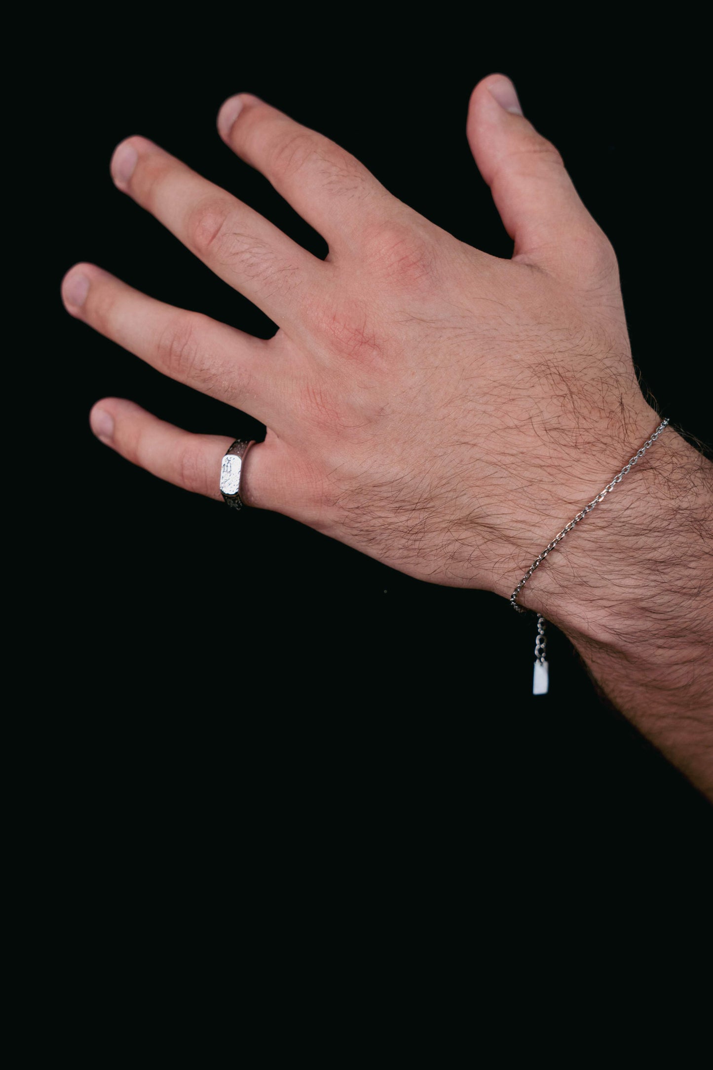 EXCITÀRE Nova Bracelet silver styled on wrist with engraved tag and matching silver EXCITÀRE ring.
