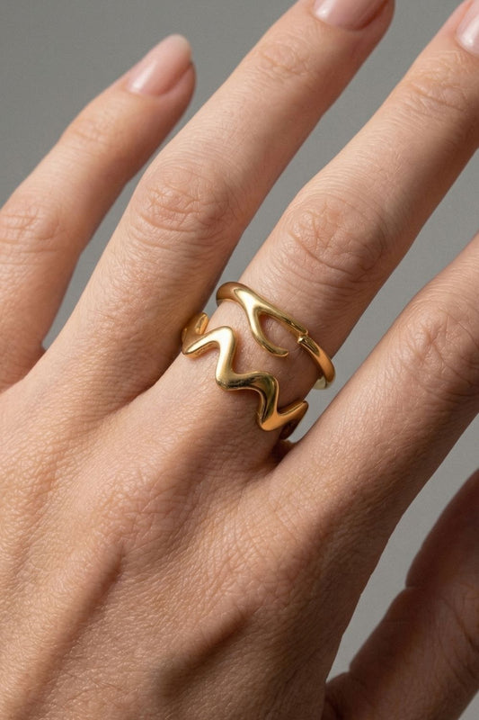 
  Gold Ellis ring on a Female finger against a neutral background

