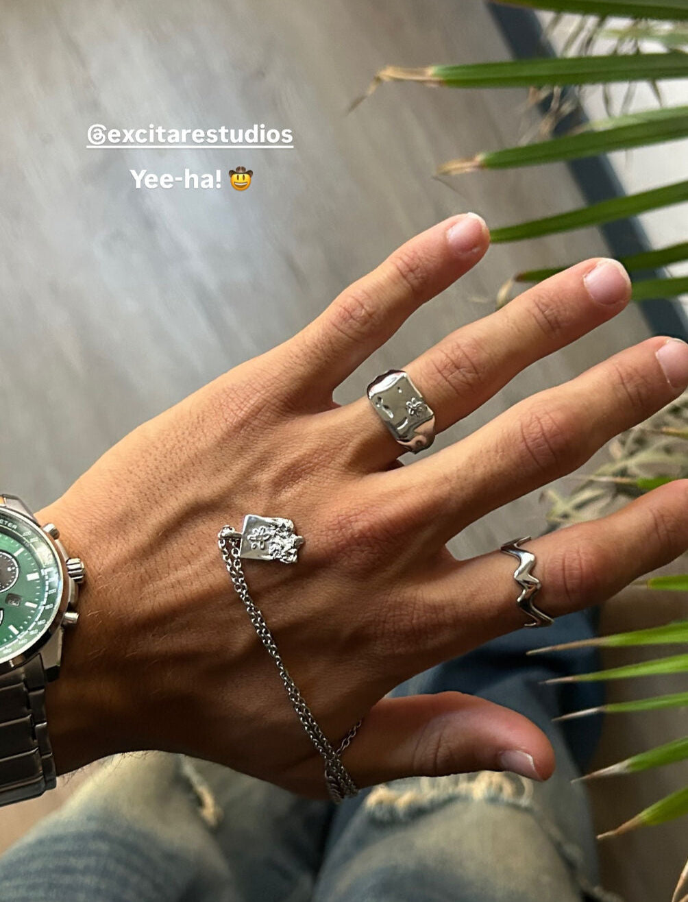Customer hand styled with Excitàre Studios jewelry, wearing the Ember Ring and Flower Ring with the Flower necklace.