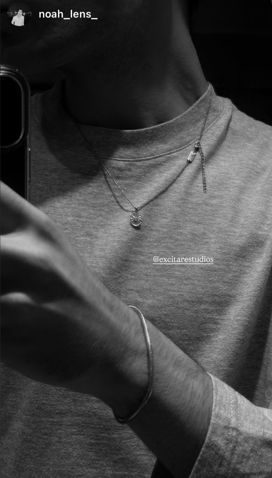 Customer wearing EXCITÀRE Eclipse Necklace layered with the Nova Chain and silver bracelet — minimalist unisex jewelry in a timeless monochrome look.
