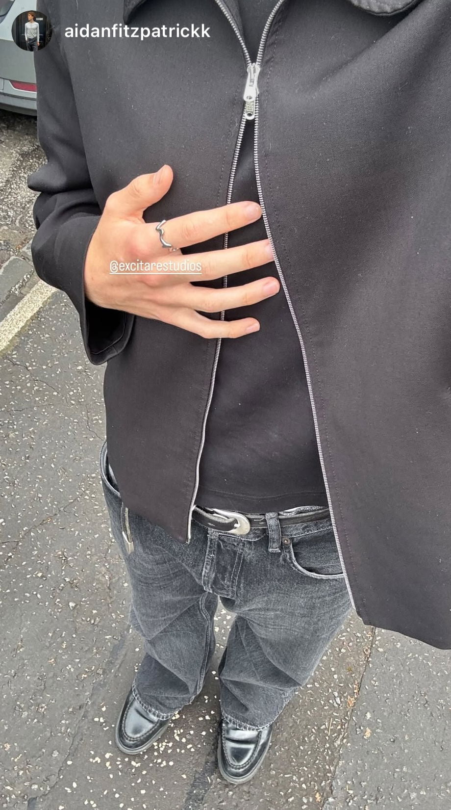 Customer wearing the EXCITÀRE Ember Ring styled with a minimalist black jacket, denim jeans, and loafers — bold unisex jewelry for everyday wear.