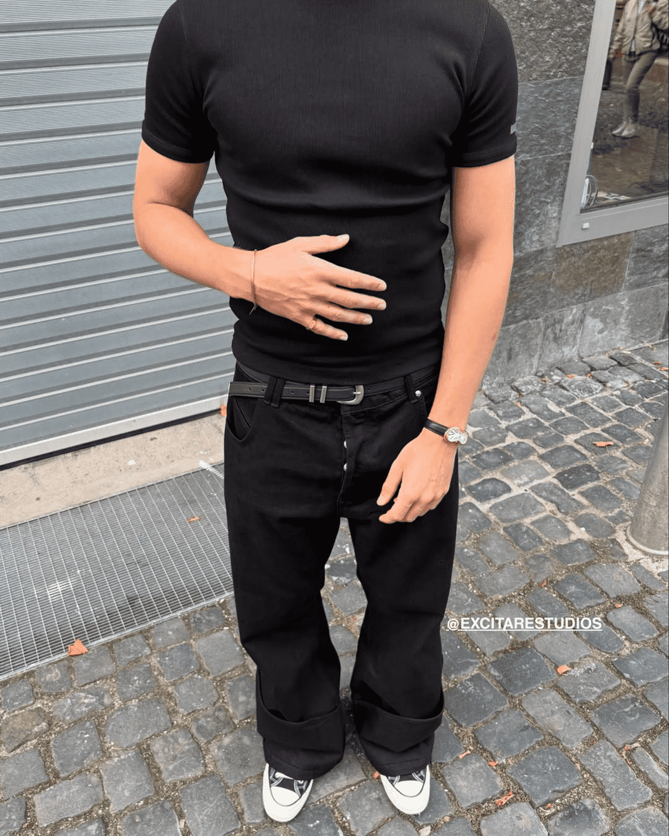 EXCITÀRE unisex ring — minimalist stainless steel jewelry styled with casual streetwear outfit in black and denim.
