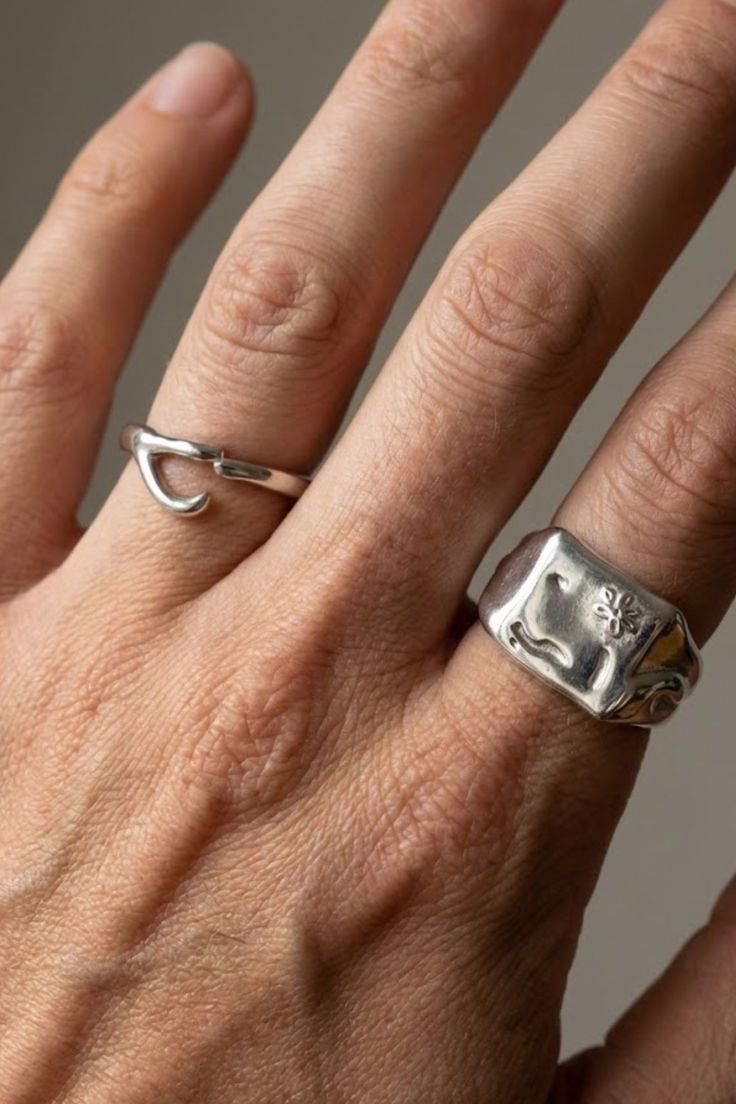 Top view of the Ellis Ring in silver, featuring a minimalist open curve design, worn on the hand.