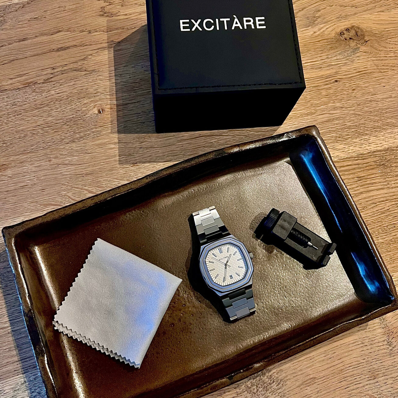 EXCITÀRE Lumen White Watch with full box contents including adjustment tool, cleaning cloth, and packaging