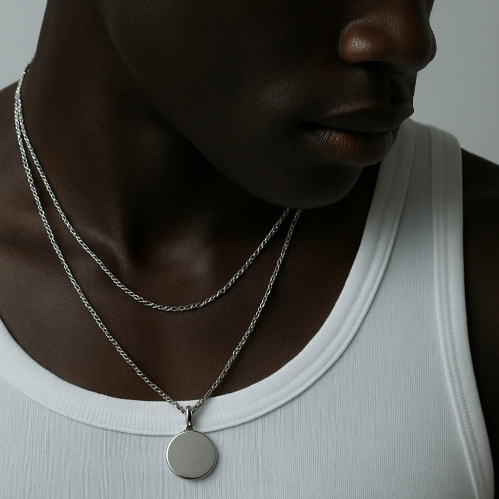 Man wearing EXCITÀRE necklace, presenting minimalist jewelry